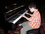 Muscat 05 Al Bustan 07 Playing Piano In Lobby There was no live entertainment, so Peter surprised us by playing the piano in the lobby of the Al Bustan Hotel. Hmm, if you look closely you�ll see that the piano was actually on auto-pilot, making its own music. Ah shucks, he sounded so good.